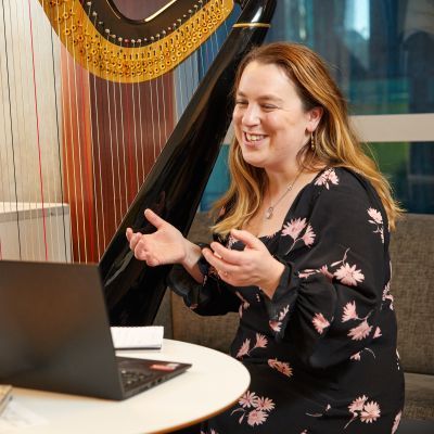 Harp next to laptop on table